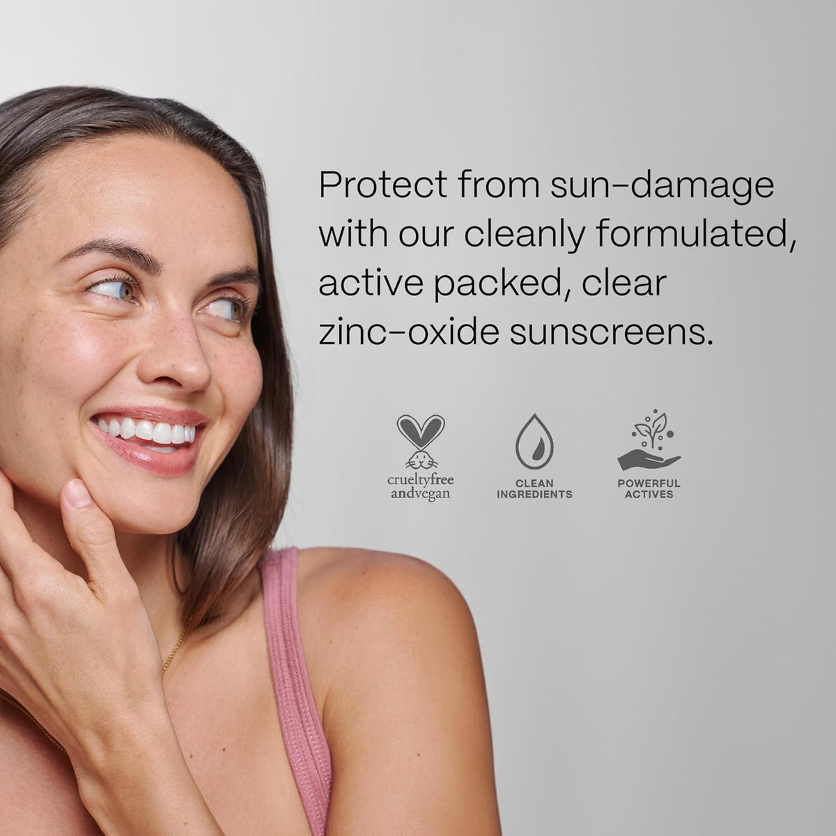 Woman with a radiant smile, promoting zinc-oxide sunscreens with text and icons on a light gray background.